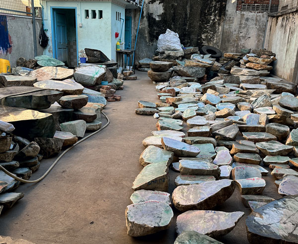 Sawn jadeite was laying all over the backyard and garage of this home/cutting shop. (Photo: Andrew Lucas. ©Guild Gemology Education)