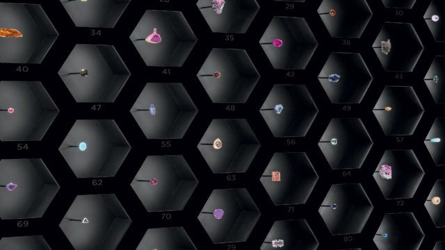 The Gem Wall installation at the Gübelin Gem Museum, featuring a honeycomb display of colored gemstones, a nod to the hexagonal crystal structure common to many minerals.